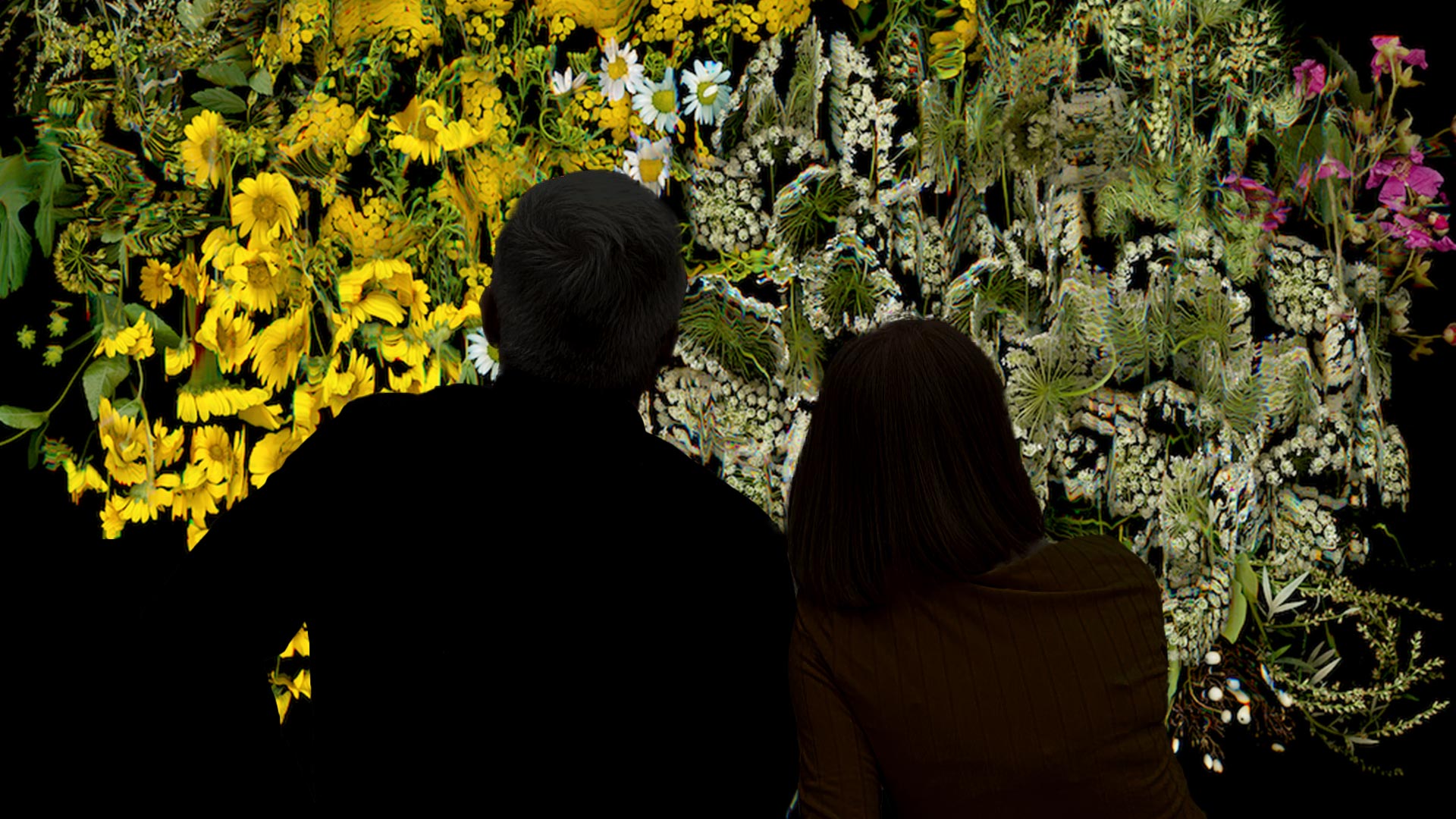 Silhouette of a couple watching a Katherine Melançon artwork