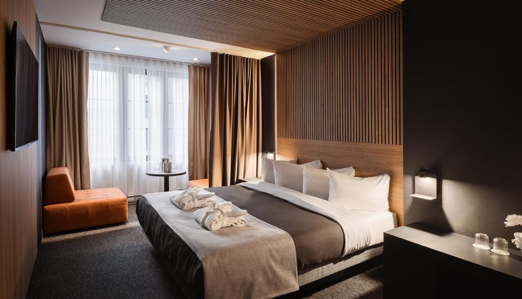 SonoLux hotel room with king size bed, wood and den