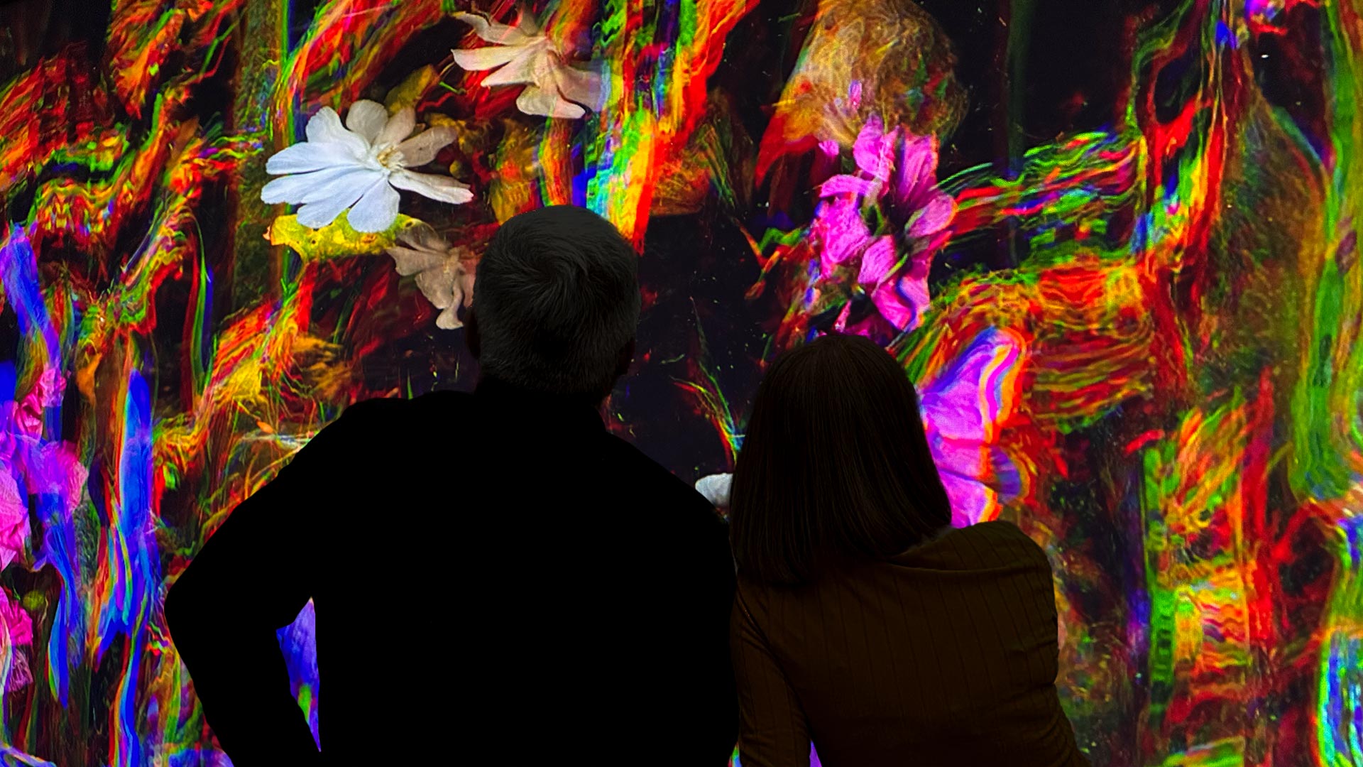 Mand and woman watch Katherine Melançon artwork